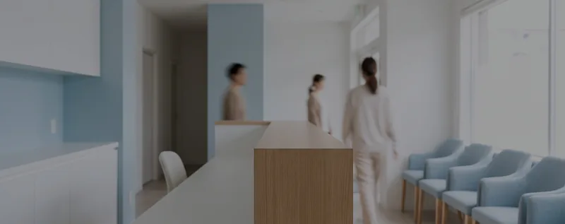 A dental clinic reception area in pale blue